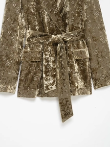 Detail view of velvet blazer with metallic floral embroidery and waist tie design