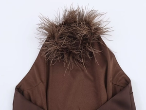 Detailed close-up of dark brown halter dress with luxury feather trim around the neckline