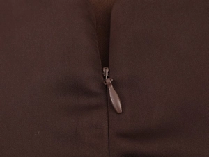 Detail of high-quality invisible zipper and diagonal weave fabric on brown dress