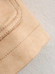 Detail of premium stitching on camel faux suede fabric for casual cropped jacket