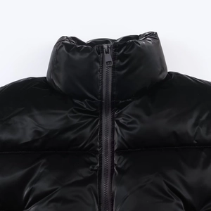 Detail view of high glossy black windproof puffer jacket with metal zipper and stand collar