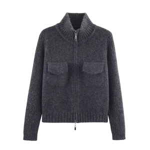 Detail of dark grey knit cardigan featuring thick texture and double zipper closure