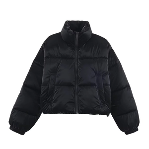 Detail view of water-resistant glossy fabric and elastic cuffs on a black puffer jacket