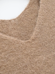 Macro detail of soft camel mohair knit sweater showing premium wool texture and neckline