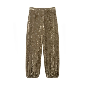 Detail of high-waist velvet lantern pants with metallic floral print and gathered cuffs