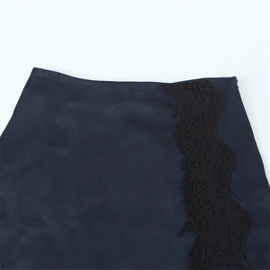 Detailed view of navy satin skirt featuring delicate black lace trim and hidden zipper