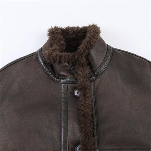 Detailed close-up of dark brown faux leather flight jacket with warm shearling collar