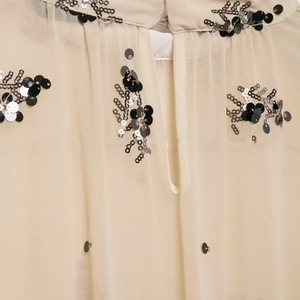 Detail of semi-transparent chiffon fabric with exquisite floral sequin embroidery