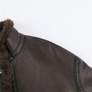 Detail of dark brown leather jacket showing soft faux fur collar and premium stitching