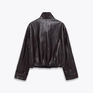 Detail view of the textured PU leather back with stand collar and elastic hem on the jacket