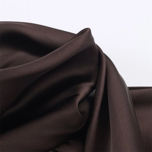 Detailed view of dark brown satin fabric with elegant drapes and smooth texture