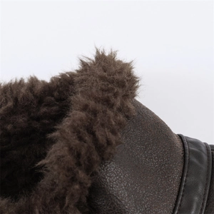 Macro shot of dark brown winter boot featuring plush fleece lining and textured suede leather