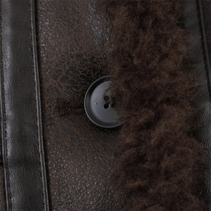 Detail of distressed dark brown faux leather jacket with plush fur trim and matte button