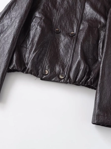 Detailed view of dark brown PU jacket featuring double-breasted buttons and ruched hem
