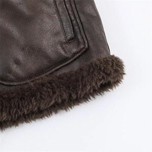 Detailed view of dark brown leather jacket with thick faux fur lining and premium stitching
