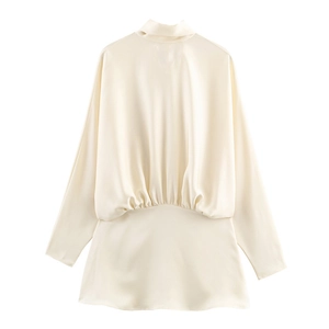 Detail of elegant cream satin mini dress with scarf neck and draped pleated waist