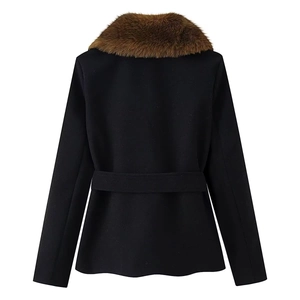 Detail of a black fitted coat featuring a brown faux fur collar and matching waist belt
