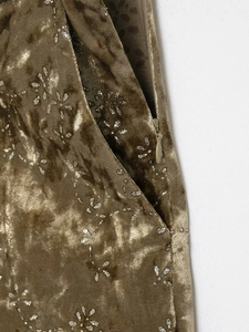 Detail of velvet blazer featuring metallic floral prints, invisible zipper, and side pocket