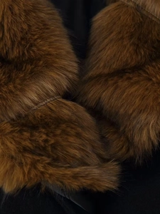 Detailed macro view of plush faux fur collar in rich brown with high density and soft texture