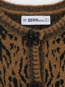 Detailed view of leopard print knit cardigan featuring a black floral beaded button