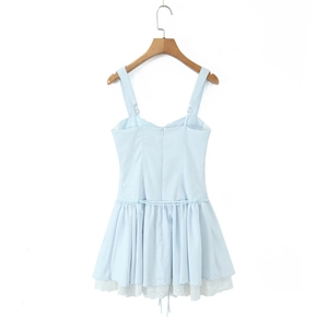 Detail of light blue slip dress featuring white lace hem and vertical stripe texture