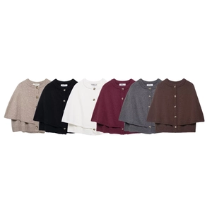 Detail view of knitted cape sweaters in six colors with single-breasted button design