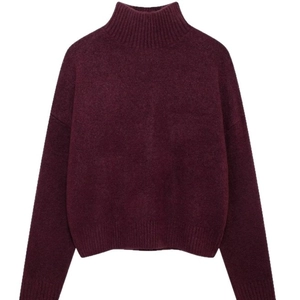 Women's turtleneck knit sweater in burgundy with drop shoulders and ribbed cuffs on white back