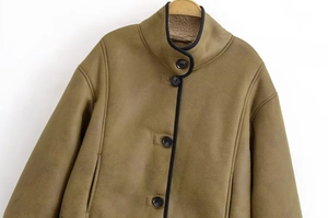 Detail of olive green faux suede jacket showing warm lamb wool lining and stand collar