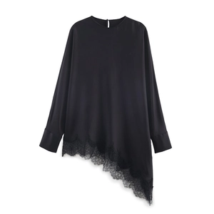 Detailed view of long-sleeve black satin blouse with asymmetric lace hem and button back