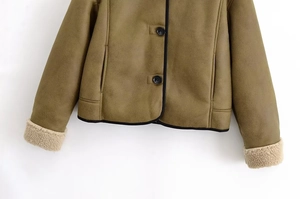Detailed macro view of army green faux suede jacket with plush faux fur cuffs and buttons