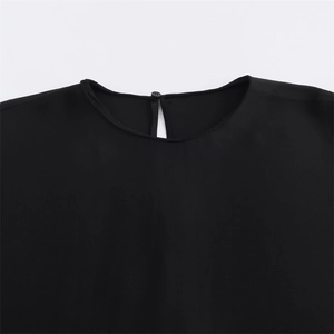 Close-up of black shirt round neckline with back keyhole cutout and small button detail