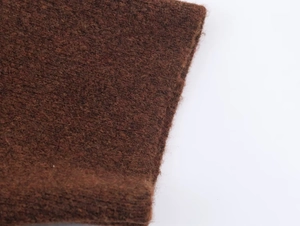 Detailed macro view of the premium brown knit fabric texture on this women's sweater