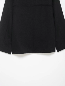 Detailed view of the back hem and seam structure on a black wool blend winter jacket