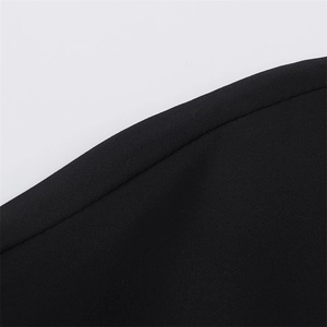 Close-up of black shirt fabric texture with high-quality stitching and woven pattern