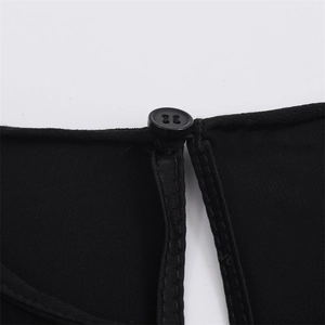 Macro shot of black asymmetric shirt with round button closure and twill fabric texture
