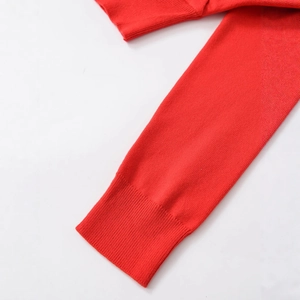 Women's red knit sweater featuring high-quality ribbed cuffs and premium textured fabric