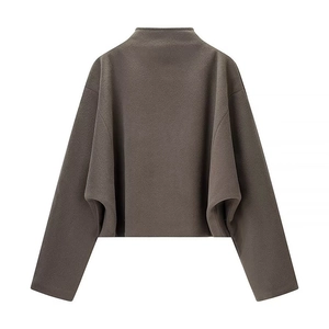 Detail of loose fit cropped dark wool jacket featuring drop shoulders and soft texture