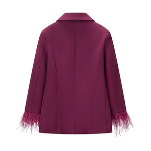 Detail view of the back of a magenta blazer featuring stylish feather-trimmed cuffs