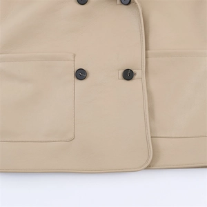 Close-up of beige leather coat featuring double-breasted black buttons and square pockets