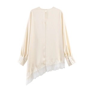 Detail of satin long sleeve blouse showing the irregular hem and white lace trim