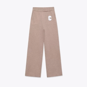 Detail of taupe wide-leg sweatpants featuring high elastic waist and white C-letter embroidery