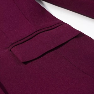 Detail of burgundy blazer showing high-quality stitching on the flap pocket and fabric