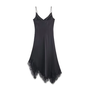 Detail of black silk satin dress showing asymmetric hem and intricate lace trimming