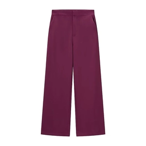 Detail of burgundy high-waisted wide-leg trousers with elegant drape and side pockets