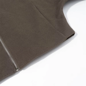 Close-up of brown wool jacket texture showing metal zipper and neat stitching detail