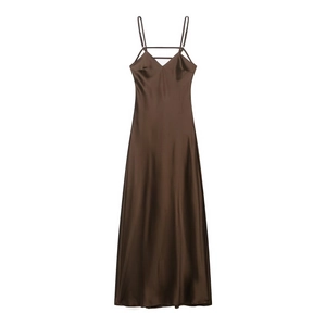 Detail of chocolate brown satin slip dress showing V-neckline with criss-cross thin straps