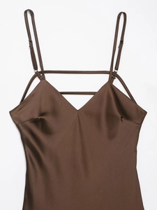 Detailed view of dark brown satin slip dress with adjustable straps and V-neckline