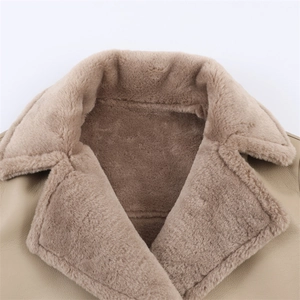 Close-up of stylish winter coat with beige leather exterior and soft brown fleece collar