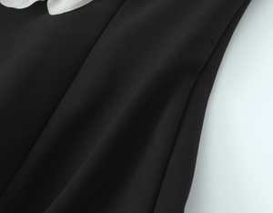 Close-up of contrast flower tube top featuring white mesh lace trim and black fabric