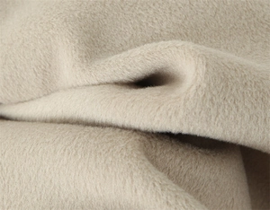 Macro detail of high-quality light beige wool blend fabric with soft brushed texture